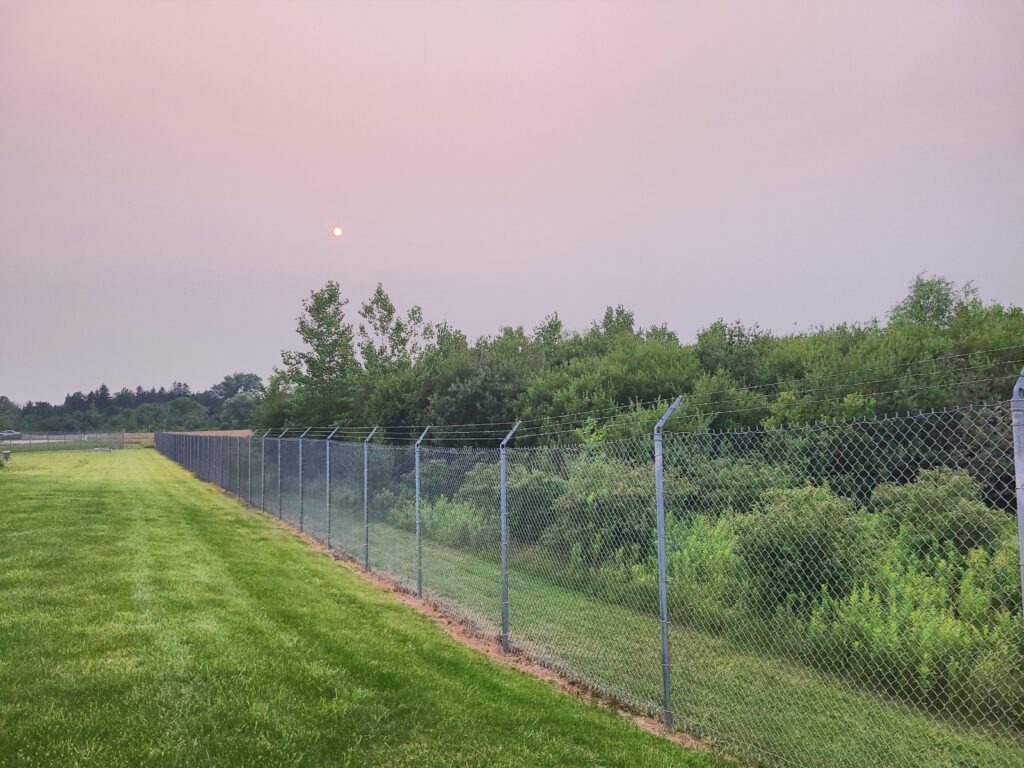 A photo of a smoke-filled sky with a red sunset.